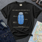 Black Comfort Colors t-shirt with blue Quarter Water graphic and text on a dark surface with denim jacket and map.