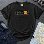 Black Comfort Colors t-shirt with NYC taxi-themed graphic on a gray surface with a denim jacket and a map.