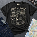 Black Comfort Colors t-shirt with 'NY Corner Store Kid' text and images on a gray surface with denim jacket and map
