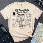 Ivory Comfort Colors T-shirt with black NYC Block Party Starter Pack front print, styled with denim jacket, camera, and subway map