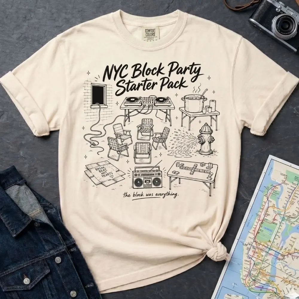 Ivory Comfort Colors T-shirt with black NYC Block Party Starter Pack front print, styled with denim jacket, camera, and subway map