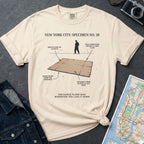 Ivory Comfort Colors T-shirt with NYC breakdance cardboard specimen front print, styled with denim jacket, camera, and subway map.