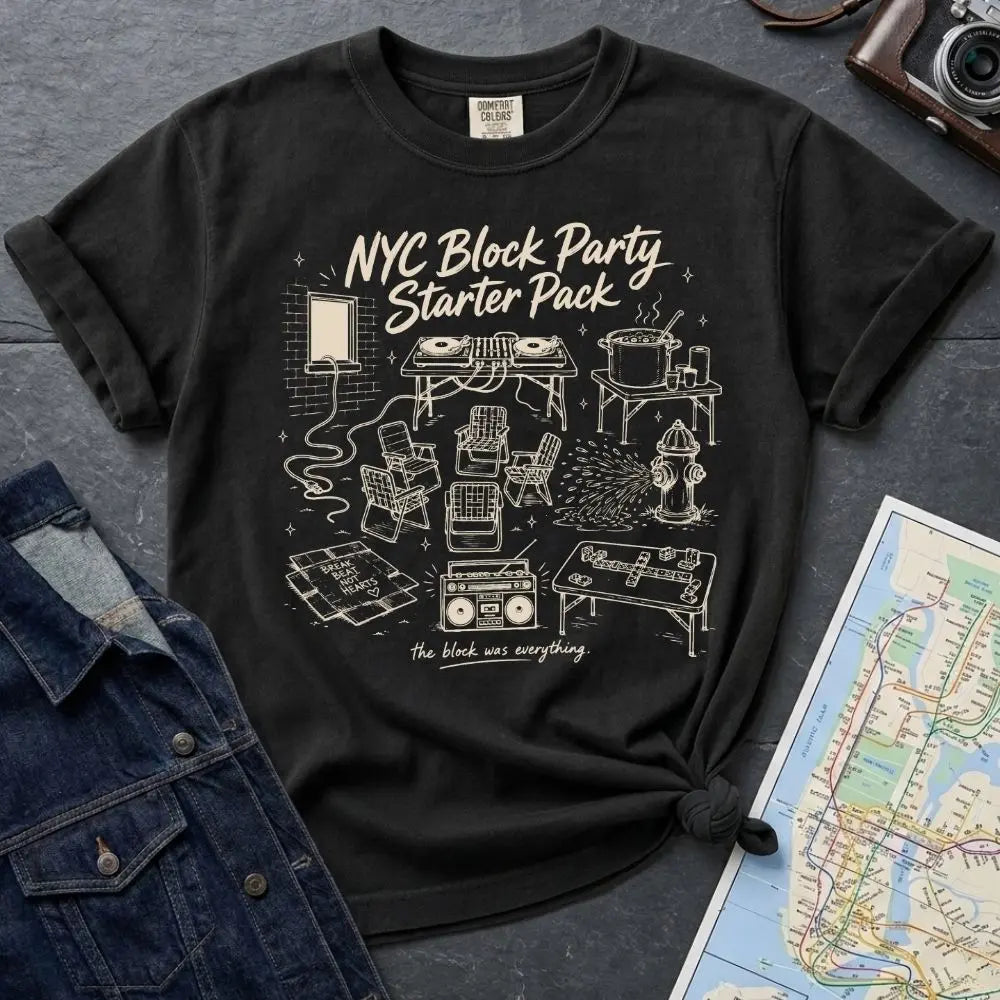 Black Comfort Colors T-shirt with off-white NYC Block Party Starter Pack front print, styled with denim jacket, camera, and subway map