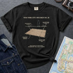 Black Comfort Colors T-shirt with NYC breakdance cardboard specimen front print, styled with denim jacket, camera, and subway map