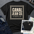 Black Comfort Colors T-shirt with off-white Canal Jean Co. NYC back print and small front chest staff print, shown as a double-sided New York nostalgia tee