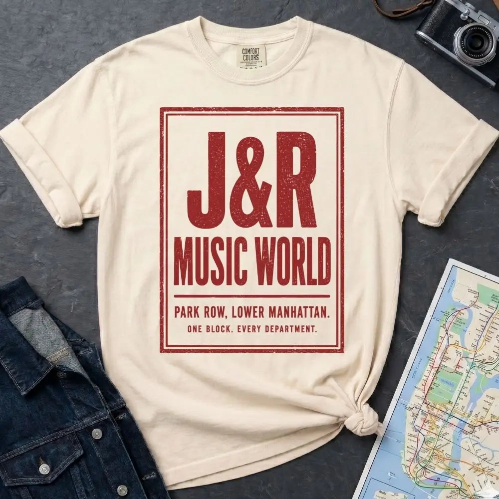 Ivory Comfort Colors T-shirt with red J&R Music World NYC front print, styled with denim jacket, camera, and subway map.