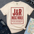 Ivory Comfort Colors T-shirt with red J&R Music World NYC front print, styled with denim jacket, camera, and subway map.