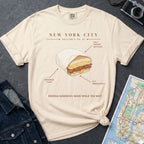 Ivory Comfort Colors  t-shirt with a graphic of a bodega sandwich and text on a dark surface with a map and jacket.