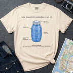 Ivory Comfort Colors t-shirt with blue Quarter Water graphic and text on a dark surface with denim jacket and map.