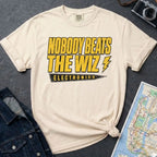 Ivory Comfort Colors T-shirt with yellow and black The Wiz Electronics NYC front print, styled with denim jacket, camera, and subway map