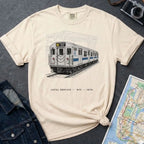 Ivory Comfort Colors T-shirt with NYC R train local service front print, styled with denim jacket, camera, and subway map