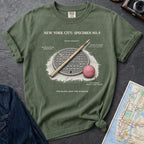 Moss colored Comfort Colors t-shirt with a stickball graphic and text on a dark surface with denim jacket and map.