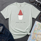 Bay colored Comfort Colors t-shirt with a piragua graphic and text, placed on a dark surface with a map and denim jacket.