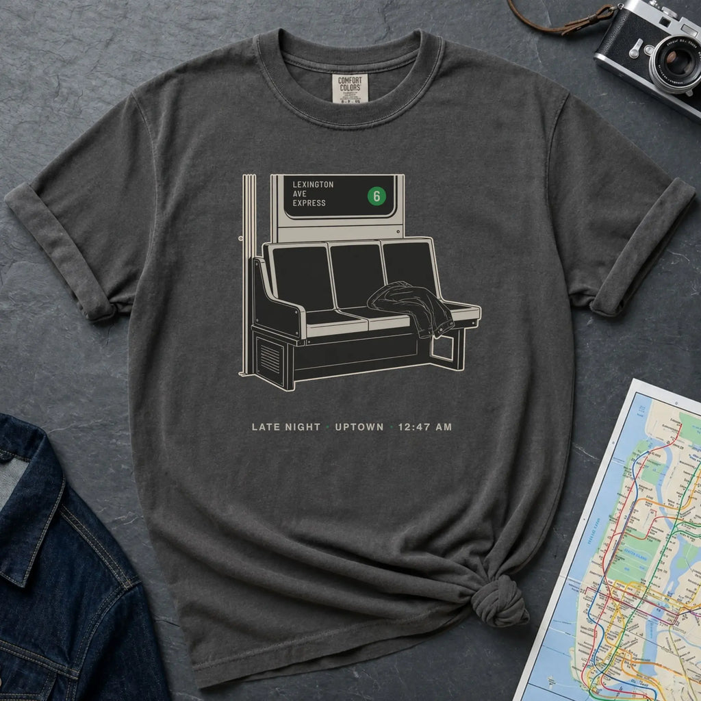 Pepper colored gray t-shirt with a graphic design of a train interior and text on a dark surface.