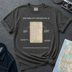 Pepper colored Comfort Colors T-shirt with NYC library loan card specimen front print, styled with denim jacket, camera, and subway map