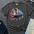 Pepper colored Comfort Colors t-shirt with a colorful graffiti NYC subway train graphic on a gray surface with a camera and map.