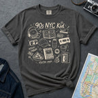 Pepper colored Comfort Colors t-shirt with '90s NYC Kid' graphic design on a dark surface with denim jacket and map.