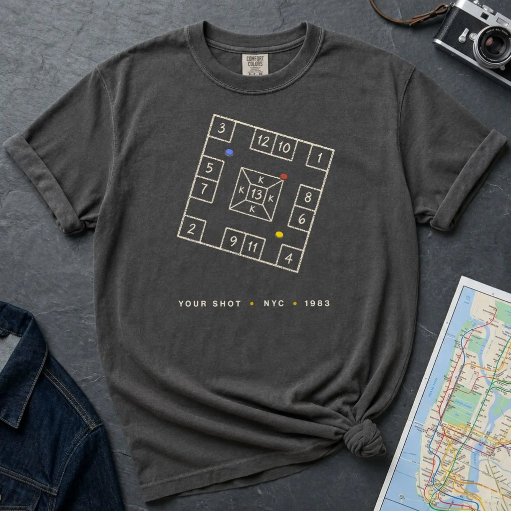 Pepper colored Comfort Colors t-shirt with New York City skelzies design on a gray surface with denim jacket and map.