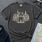 Pepper Colored Comfort Colors t-shirt featuring a minimalist Shiba Inu graphic in front of the New York City skyline on a dark surface with a denim jacket and a map.