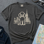 Pepper colored Comfort Colors t-shirt with a Poodle and cityscape design on a dark surface with a denim jacket and a map.