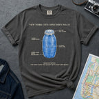 Pepper colored Comfort Colors t-shirt with blue Quarter Water graphic and text on a dark surface with denim jacket and map.