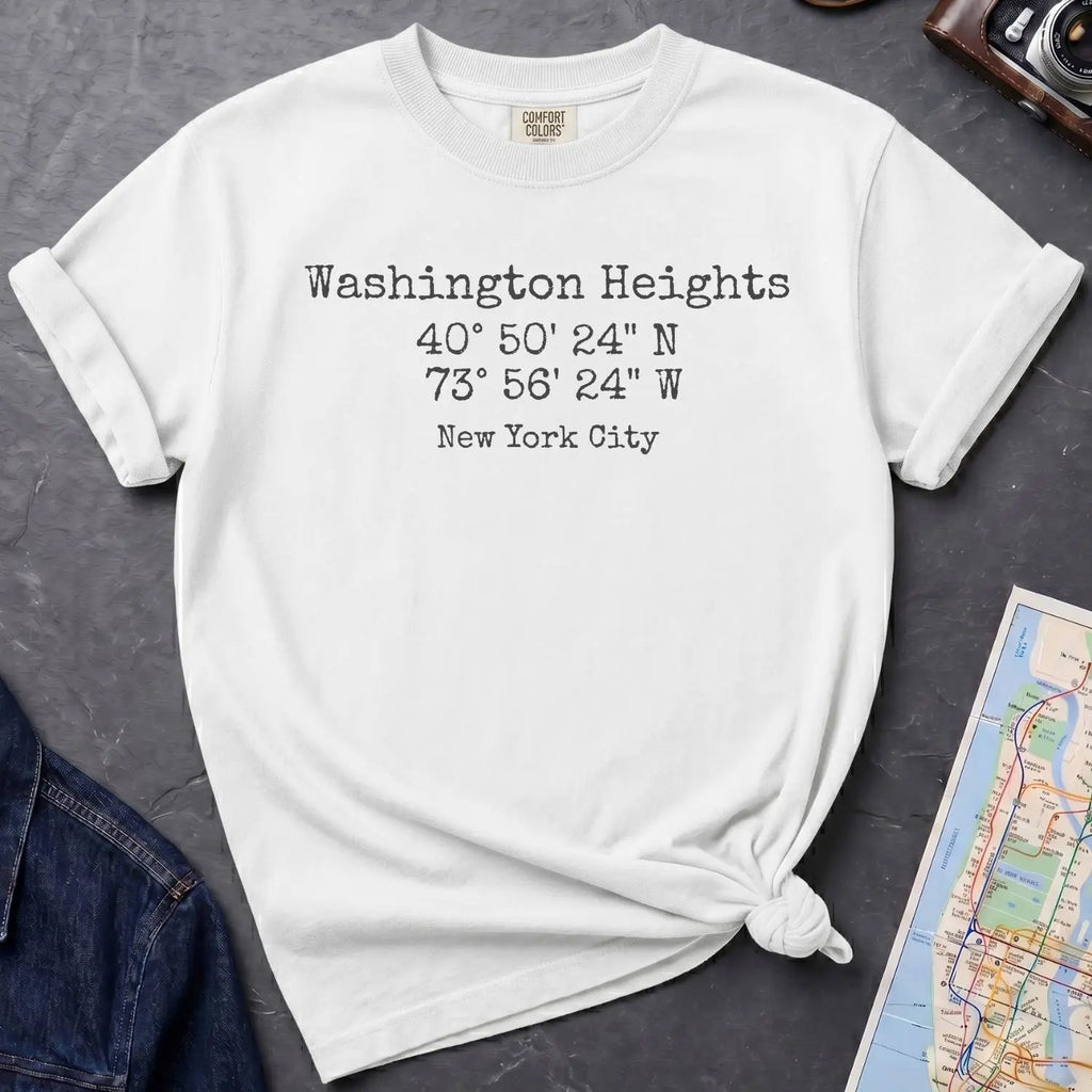 White Comfort Colors t-shirt with 'Washington Heights' text with coordinates and 'New York City' on a dark surface with a map and denim jacket.