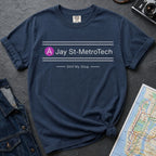 Navy blue t-shirt with 'Jay St-MetroTech' design on a dark surface with a map and denim jacket.