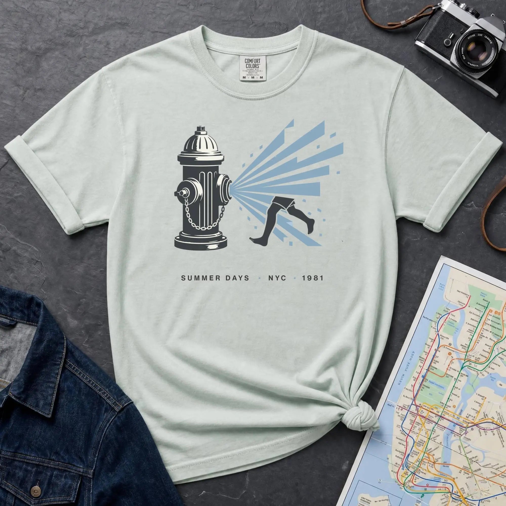 Bay colored Comfort Colors t-shirt featuring a vintage NYC fire hydrant spraying water with “Summer Days • NYC • 1981” text.