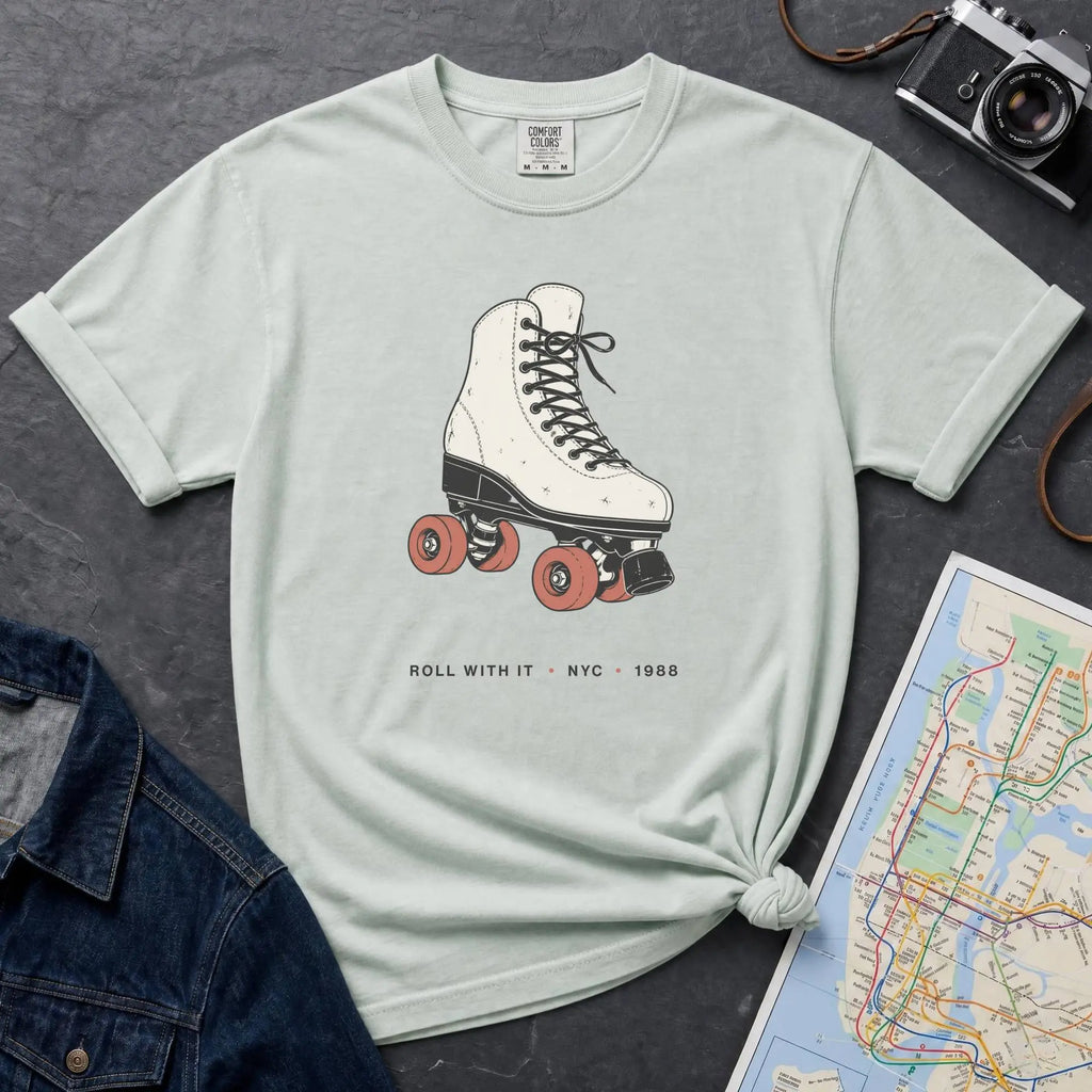 Bay colored Comfort Colors t-shirt featuring a vintage roller skate graphic with “Roll With It • NYC • 1988” text.