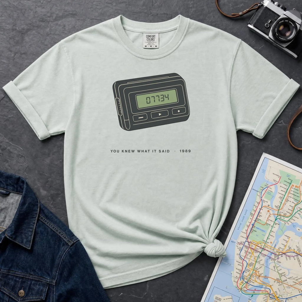 Bay colored Comfort Colors t-shirt featuring a retro pager graphic with “07734” on the screen and “You knew what it said • 1989” text.