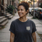 Pepper colored Comfort Colors T-shirt with ivory Bleecker Bob’s Records NYC small front chest print, while standing on a city street.