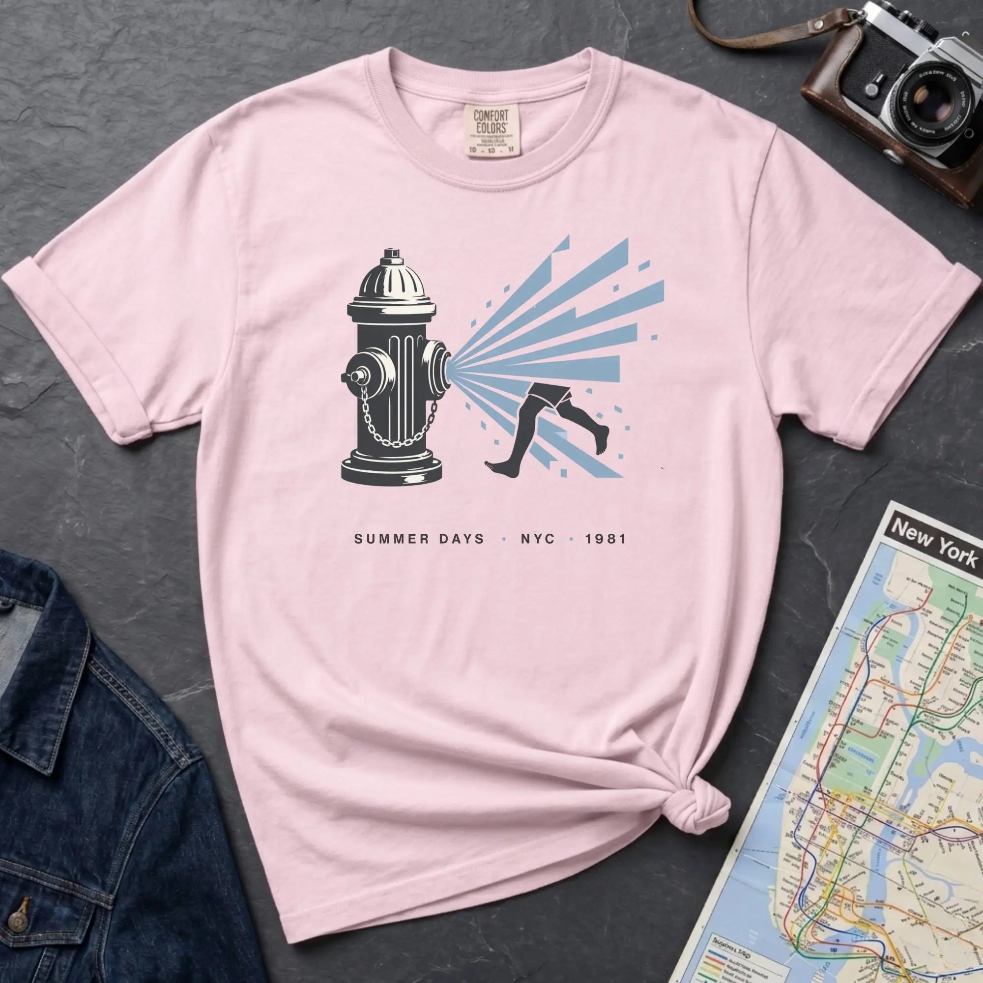 Pink Comfort Colors t-shirt featuring a vintage NYC fire hydrant spraying water with “Summer Days • NYC • 1981” text.