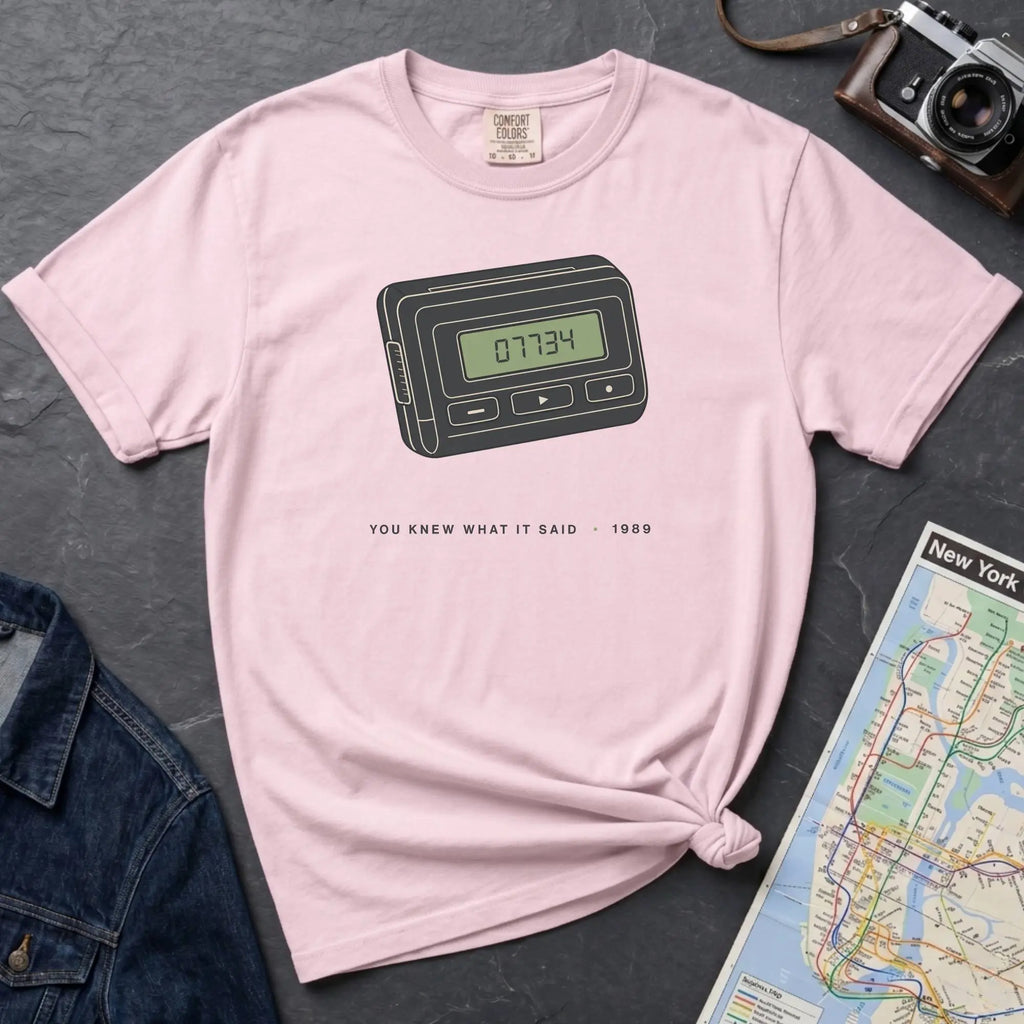 Pink Comfort Colors t-shirt featuring a retro pager graphic with “07734” on the screen and “You knew what it said • 1989” text.