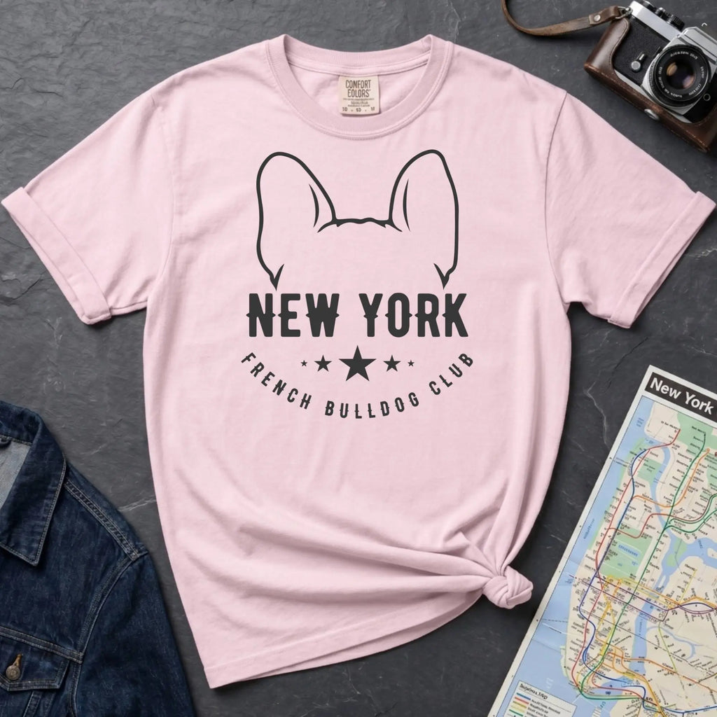 Pink Comfort Colors t-shirt featuring a New York French Bulldog Club graphic with bold text, outlined French bulldog ears, stars, and a minimalist black design.