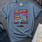 Blue Comfort Colors t-shirt featuring a colorful B-Boy New York graphic with a breakdancer in front of a graffiti brick wall.
