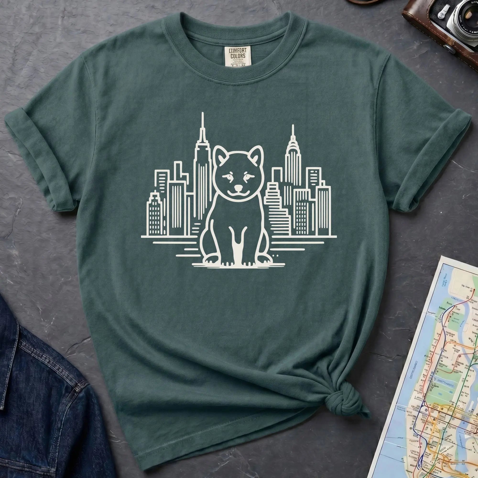 Blue Spruce Comfort Colors t-shirt featuring a minimalist Shiba Inu graphic in front of the New York City skyline.