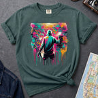 Blue Spruce t-shirt with a graphic of a person spray painting a colorful mural on a brick wall.