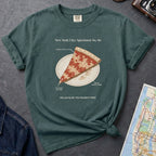 Blue spruce Comfort Colors t-shirt featuring a vintage New York City dollar slice pizza graphic with specimen-style callouts and a folded slice on a paper plate.