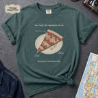 Blue Spruce Comfort Colors t-shirt featuring a vintage New York City dollar slice pizza graphic with specimen-style callouts and a folded slice on a paper plate.