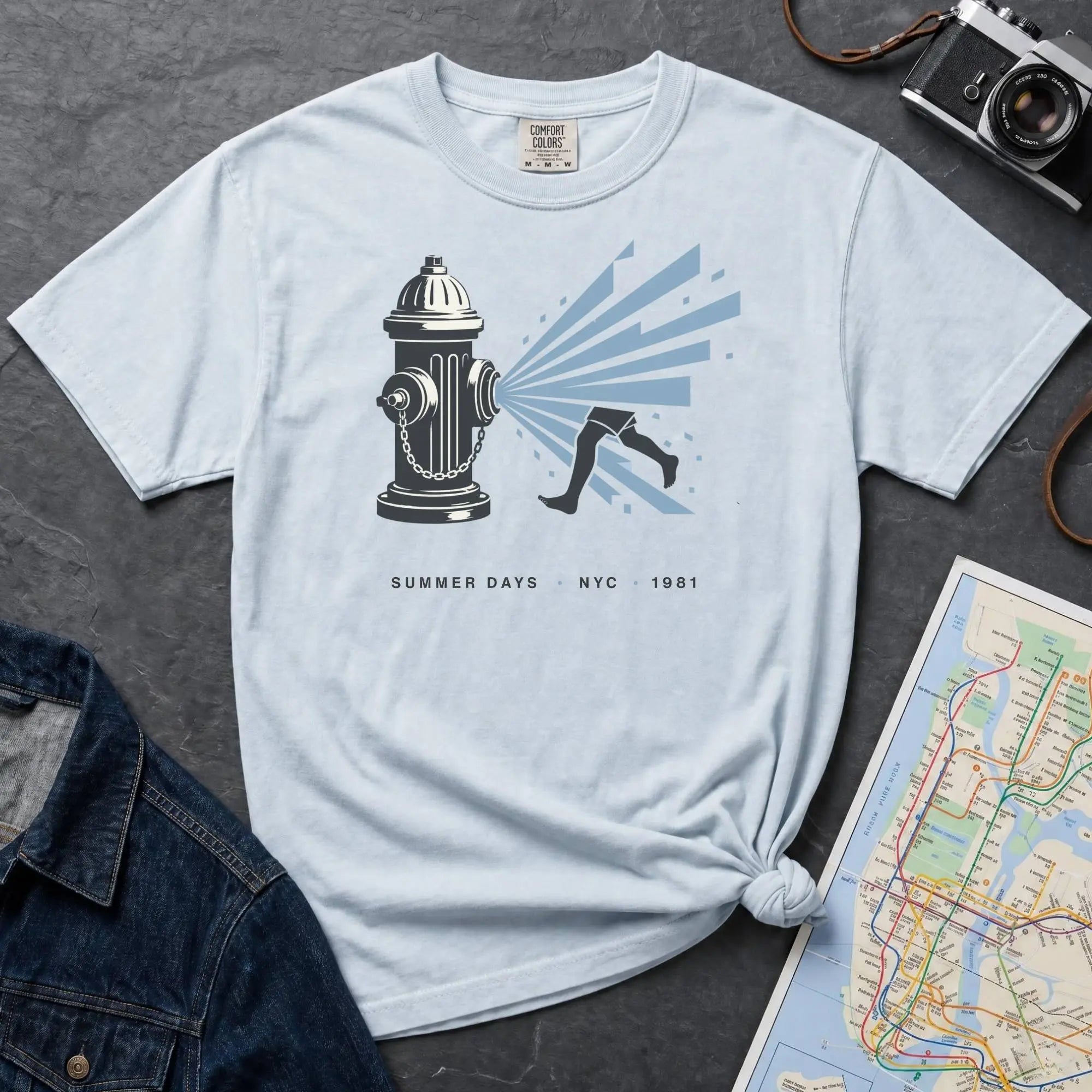 Light blue Comfort Colors t-shirt featuring a vintage NYC fire hydrant spraying water with “Summer Days • NYC • 1981” text.