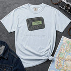 Light blue Comfort Colors t-shirt featuring a retro pager graphic with “07734” on the screen and “You knew what it said • 1989” text.