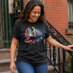 Woman wearing a black Comfort Colors t-shirt with a colorful graffiti NYC subway train graphic, standing on a street.