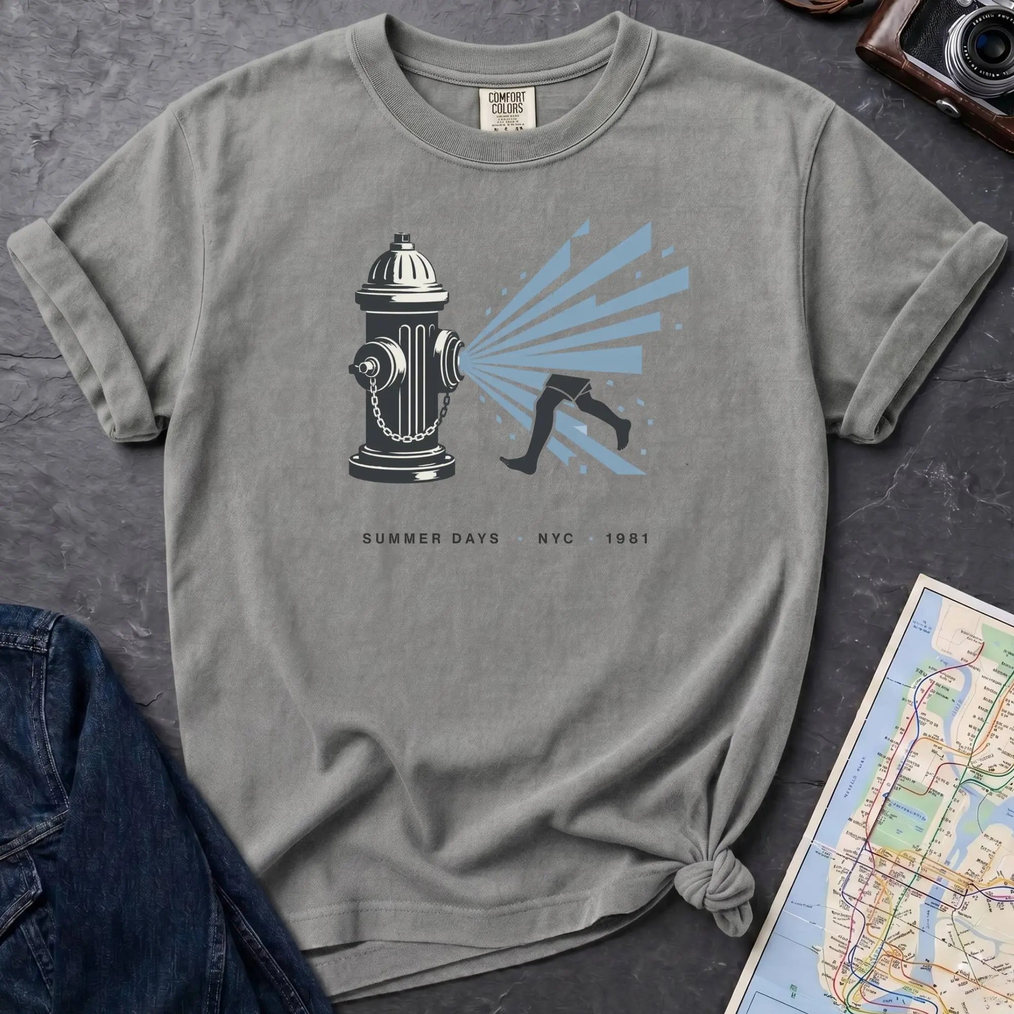 Granite colored Comfort Colors t-shirt featuring a vintage NYC fire hydrant spraying water with “Summer Days • NYC • 1981” text.
