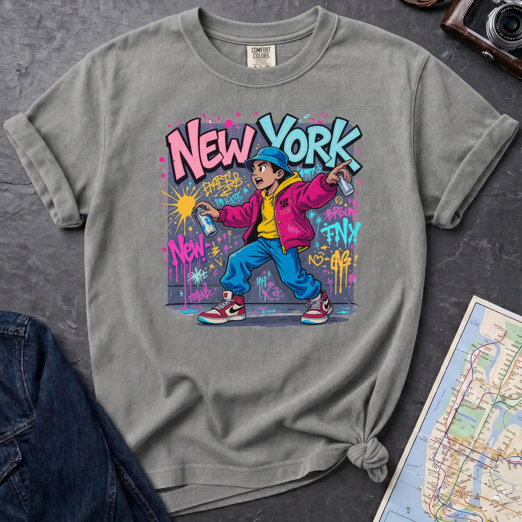 Granite colored Comfort Colors t-shirt featuring a colorful NYC graffiti-style New York graphic with a young street artist holding a spray paint can
