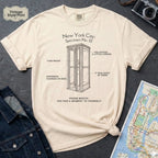 Ivory Comfort Colors t-shirt featuring a vintage New York City phone booth graphic with specimen-style callouts and “Phone Booth: You Had a Moment to Yourself” text.