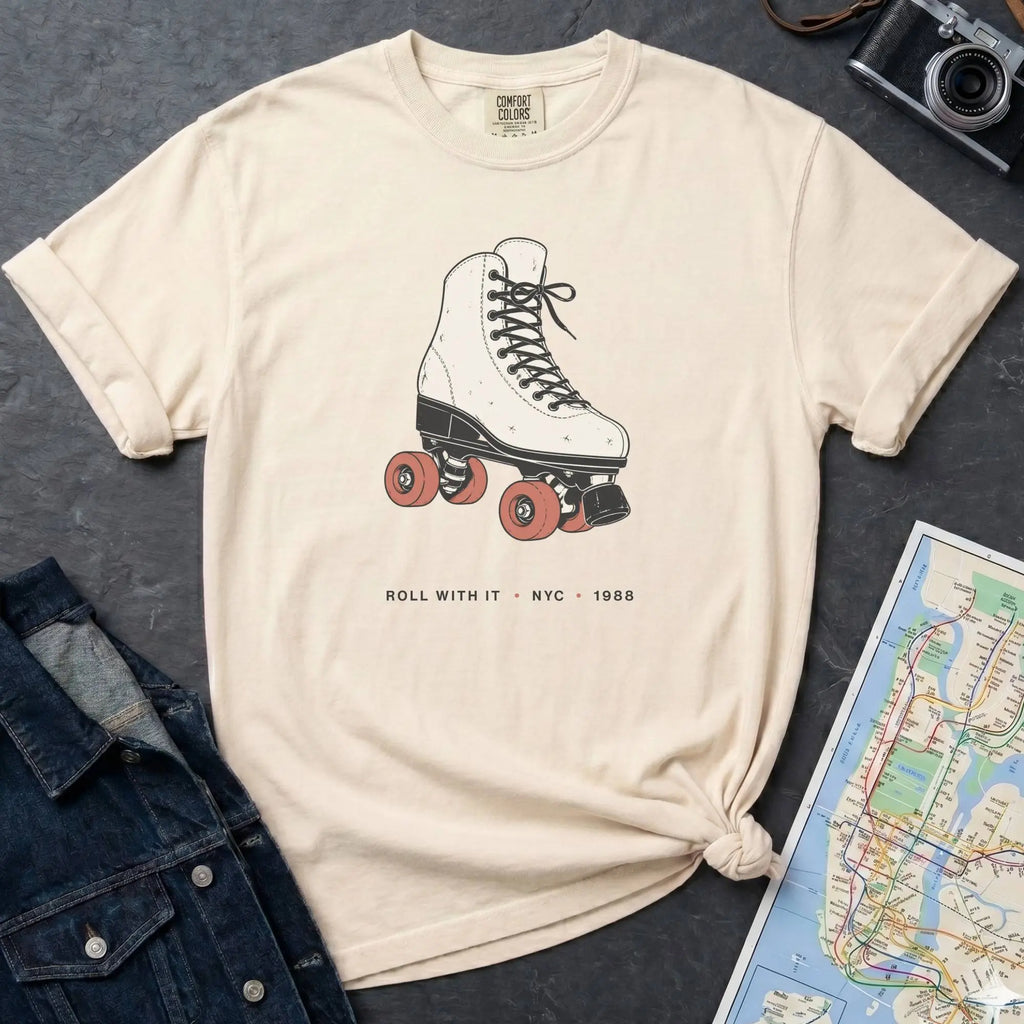 Ivory Comfort Colors t-shirt featuring a vintage roller skate graphic with “Roll With It • NYC • 1988” text.