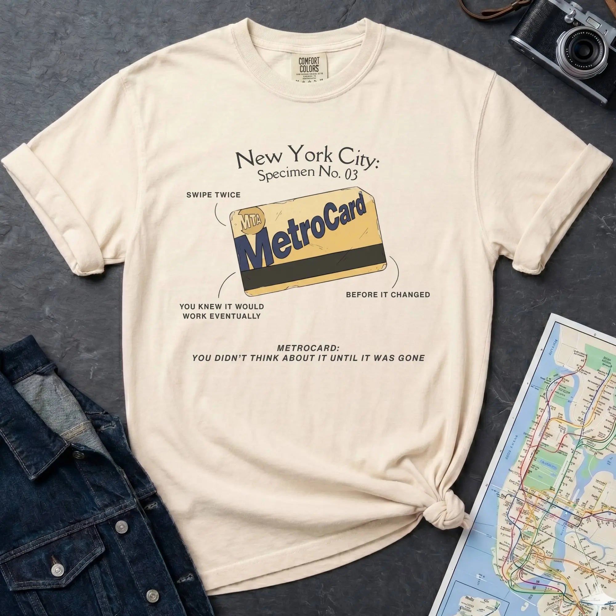 Ivory Comfort Colors t-shirt featuring a vintage New York City MetroCard graphic with specimen-style callouts and “You didn’t think about it until it was gone” text.