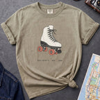 Khaki colored Comfort Colors t-shirt featuring a vintage roller skate graphic with “Roll With It • NYC • 1988” text.