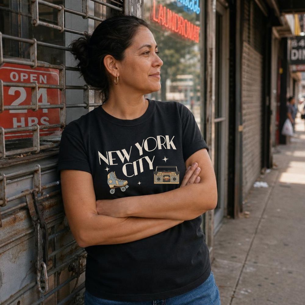 Woman wearing a 'New York City' t-shirt standing in front of a laundromat.
