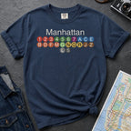 Navy Comfort Colors t-shirt featuring a minimalist Manhattan subway line graphic with colorful NYC train icons.
